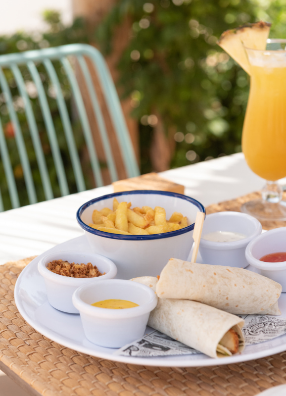 Burritos with french fries accompanied by different types of sauces