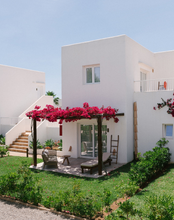 Nice terrace of one of the rooms adorned with Buganvilias