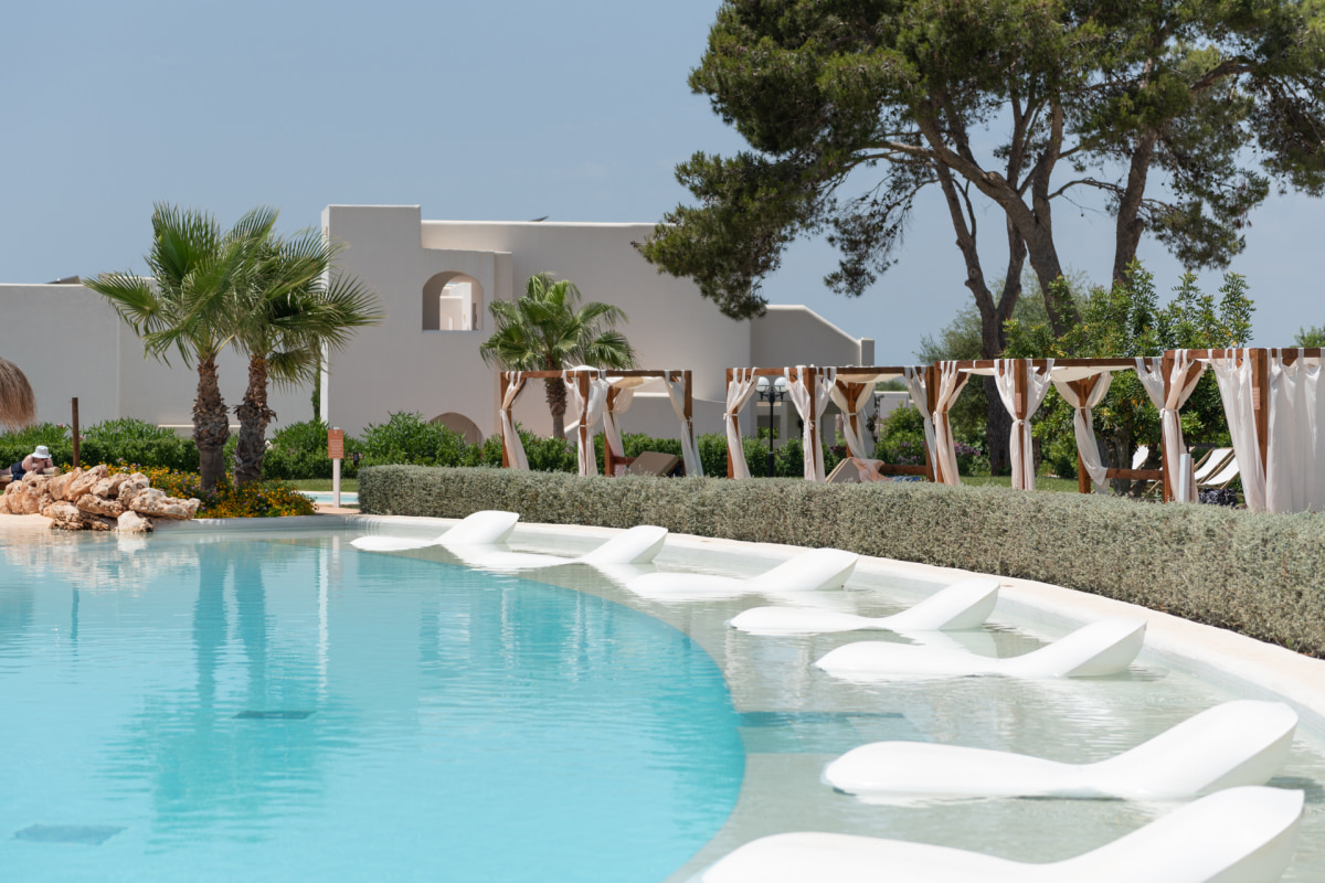 Pool area with Balinese beds and submerged sunbeds