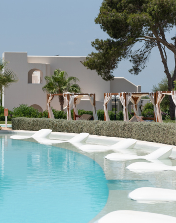 Pool area with Balinese beds and submerged sunbeds