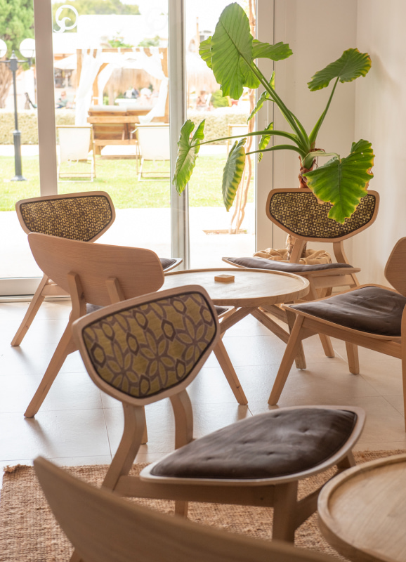 Indoor area next to the hotel pool with nice upholstered chairs