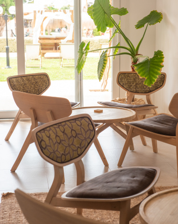 Indoor area next to the hotel pool with nice upholstered chairs