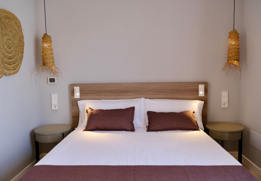 Double bed with lamps and wicker decorations